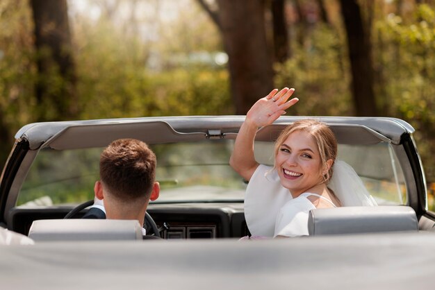 Just married couple with their car