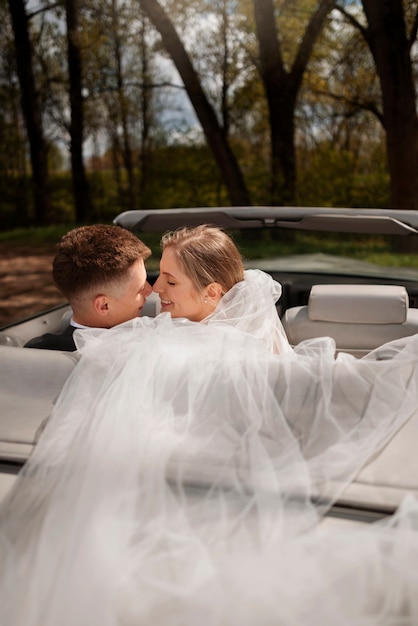 Free photo just married couple with their car