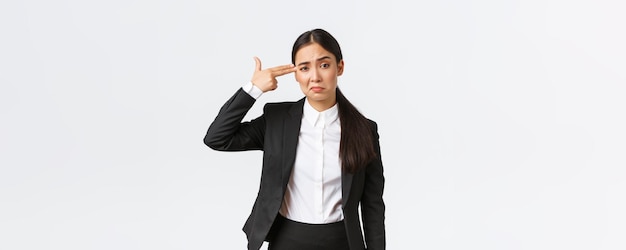 Just shoot me please bothered and fed up asian saleswoman hate her work standing in business suit sh