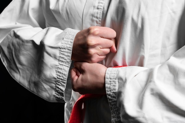 Karate athlete with red belt posing closeup