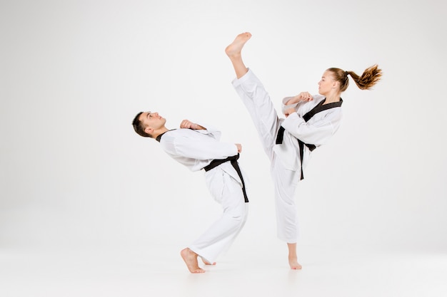 The karate girl and boy with black belts
