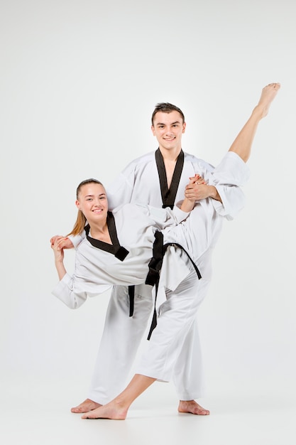 Free photo the karate girl and boy with black belts
