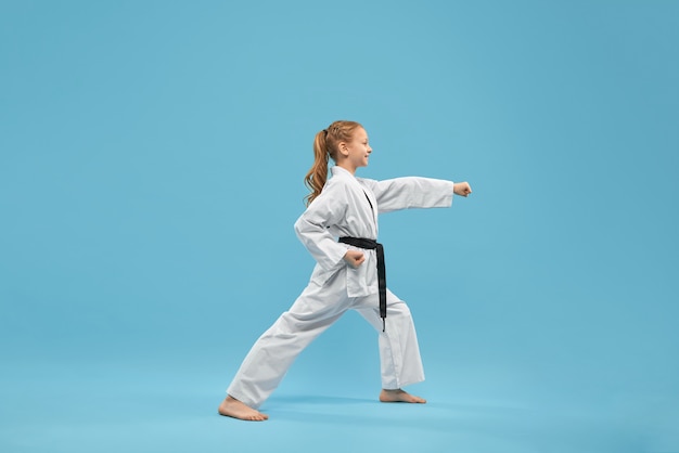 Free photo karate girl with black belt practicing martial arts.