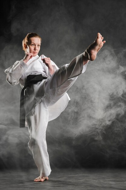 Karate woman in action full shot