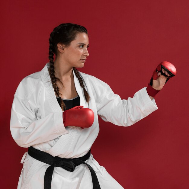 Karate woman in action isolated in red background