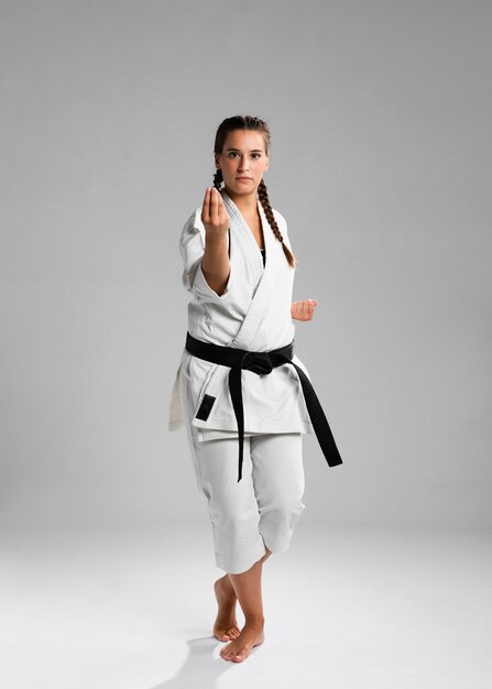 Karate woman in action isolated in white background