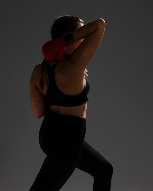 Karate woman from behind shot on dark background