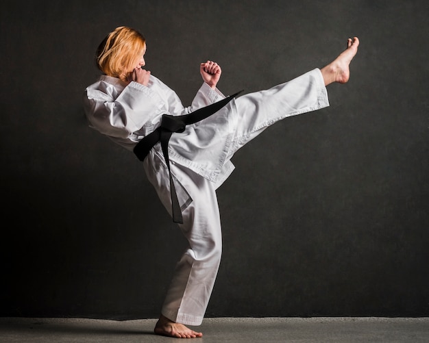 Karate woman kicking full shot