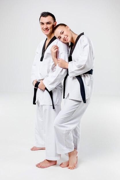 The karate woman and man with black belts