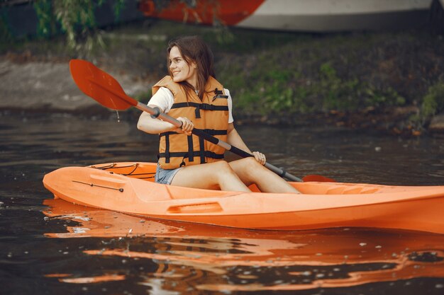 Kayaking. A woman in a kayak. Girl paddling in the water.