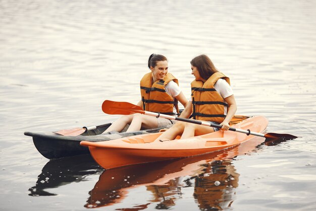 Kayaking. A women in a kayak. Girls paddling in the water.