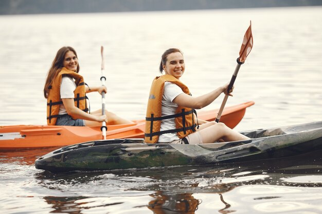 Kayaking. A women in a kayak. Girls paddling in the water.