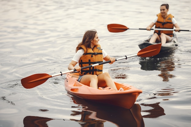 Kayaking. A women in a kayak. Girls paddling in the water.