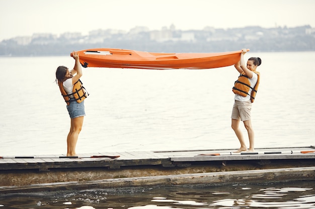 Kayaking. A women in a kayak. Girls prepare to padding on a lake.