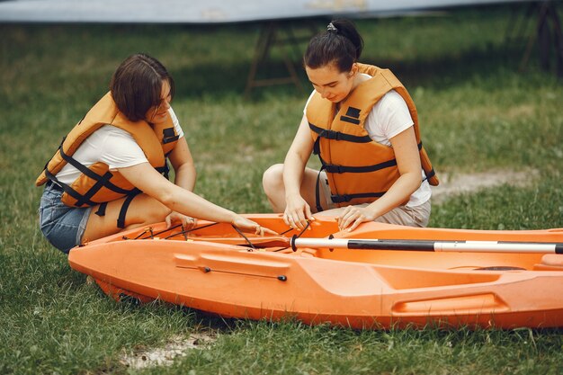 Kayaking. A women in a kayak. Girls prepare to padding on a lake.