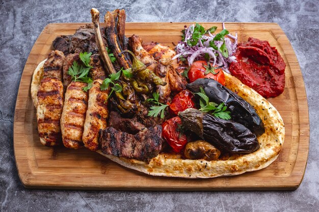 Kebab platter with lamb and chicken lula and tikka kebabs grilled vegetables with red onion salad