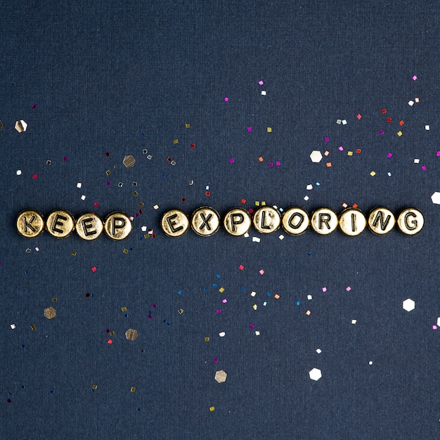 Free photo keep exploring beads text typography on blue