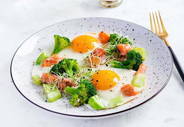Ketogenic/paleo diet. Fried eggs, salmon, broccoli and microgreen.  Keto breakfast. Brunch.