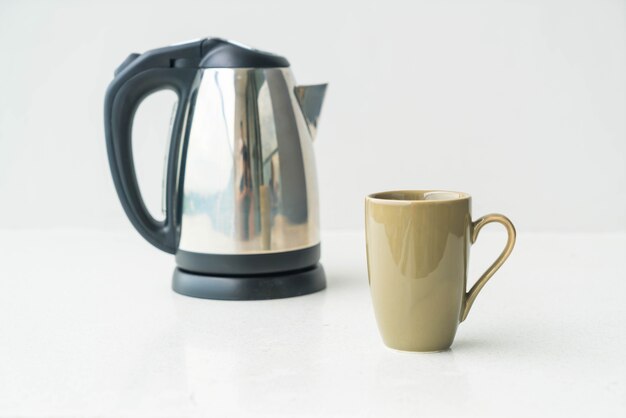 kettle and cup  on wall background