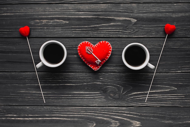 Key on heart between coffee cus