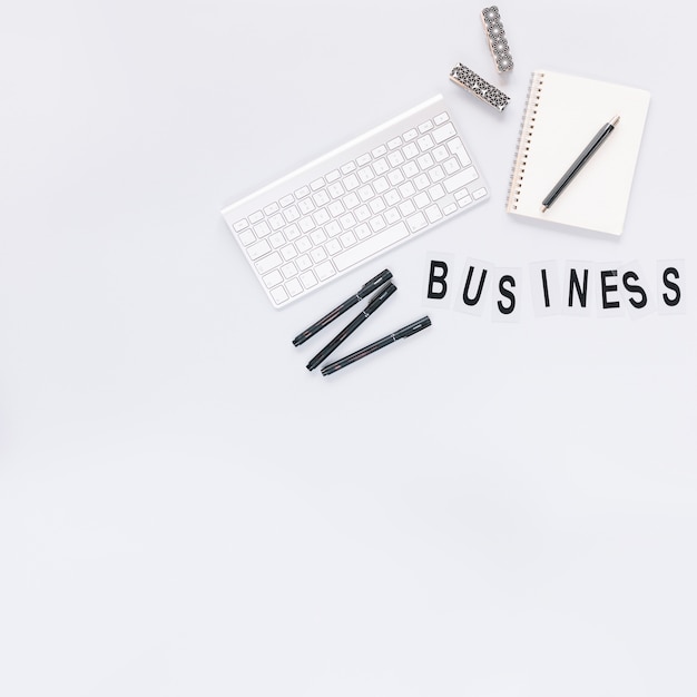 Free photo keyboard; pen and diary with business word on white background
