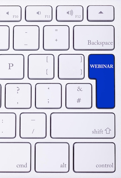 Free photo keyboard with webinar text on blue button in close up