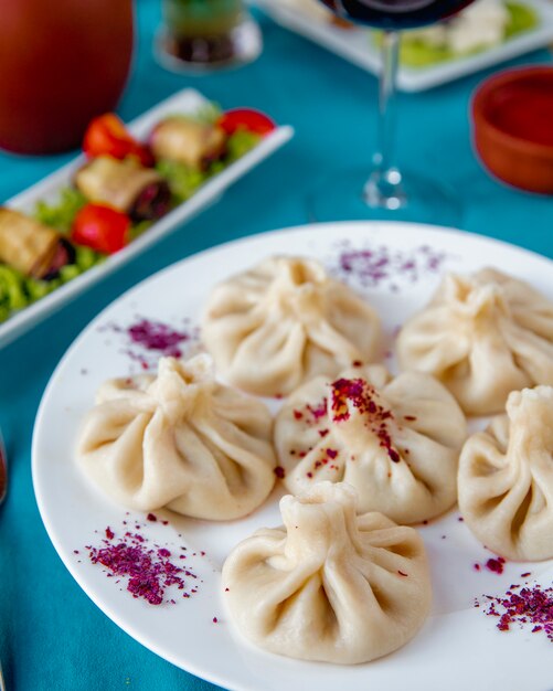 Khinkali served with eggplant rolls