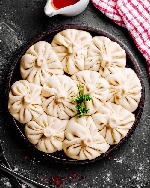 Khinkali served with greens and sauce