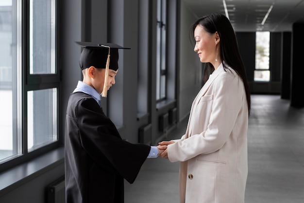 Kid Celebrating Kindergarten Graduation With Parent