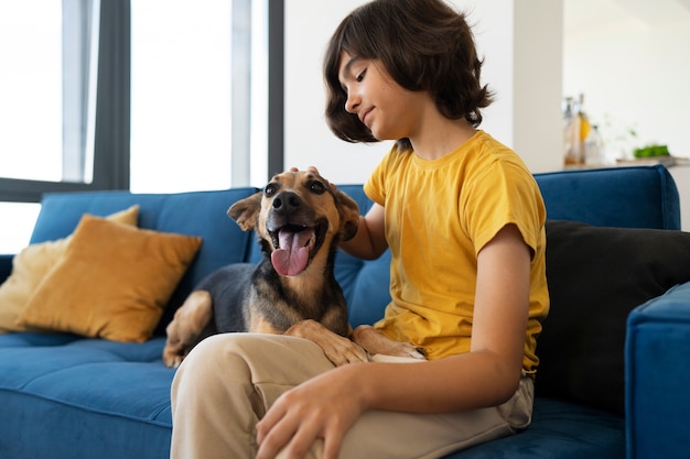 Free photo kid cleaning dog side view