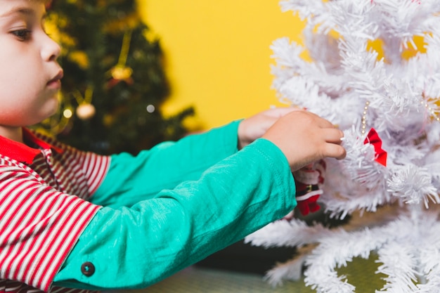 Kid decorating christmas tree