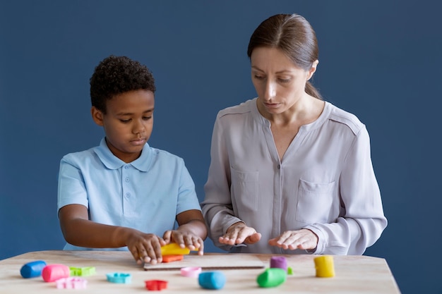 Kid doing a occupational therapy session with a psychologist