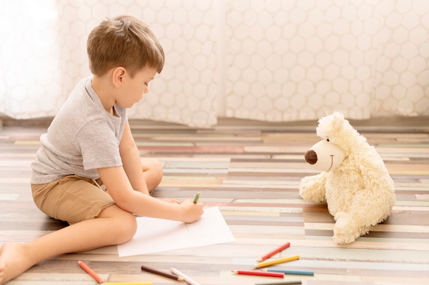 Kid drawing on the floor