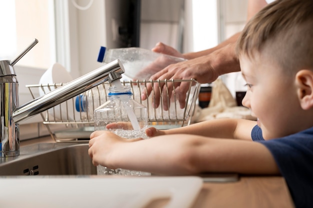 Kid filling bottle with water