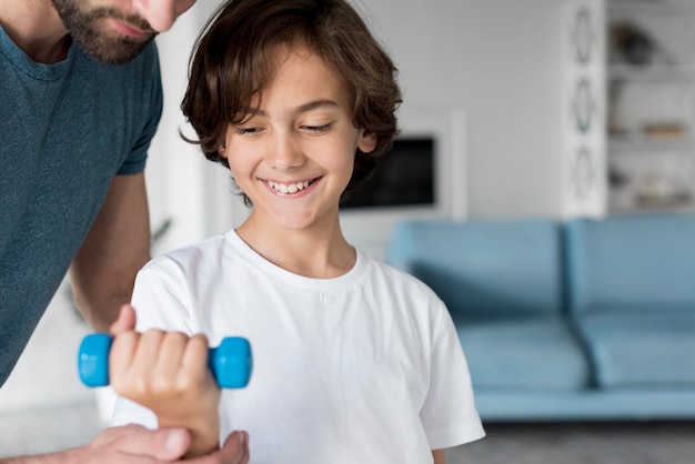 Kid and his father doing sport at home