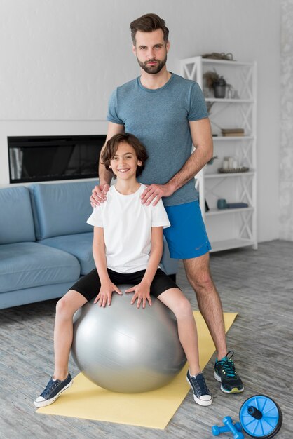 Kid and his father doing sport at home