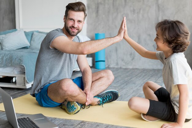 Kid and his father doing sport at home