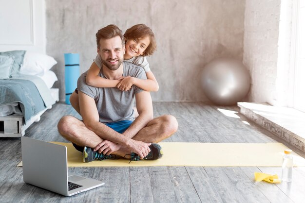 Kid and his father doing sport at home