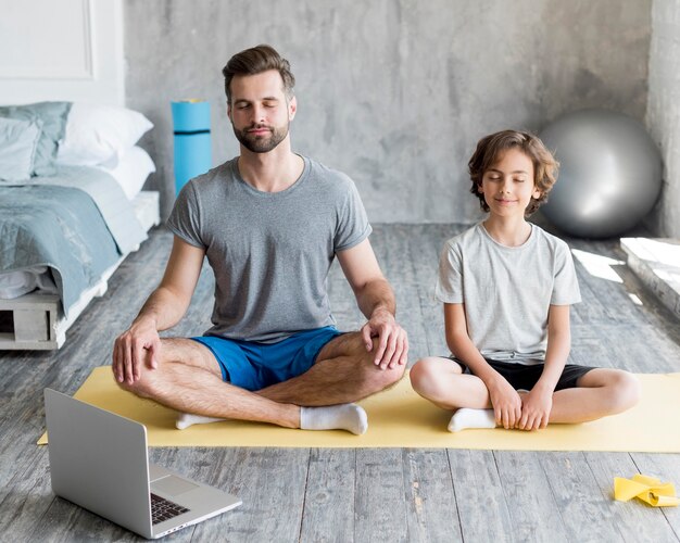 Kid and his father doing sport at home