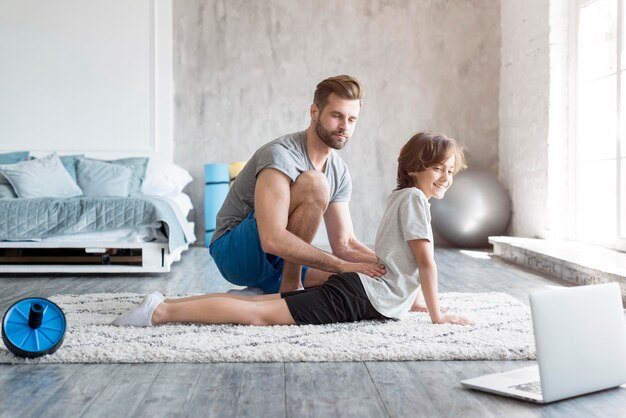 Kid and his father doing sport at home