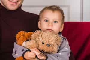 Free photo kid holding teddy bear