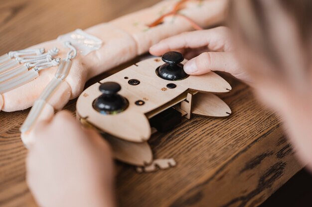 Kid holding a wooden controller