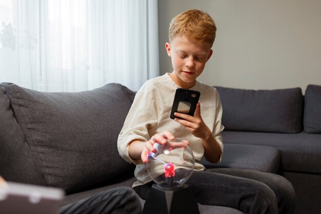 Kid interacting with a plasma ball