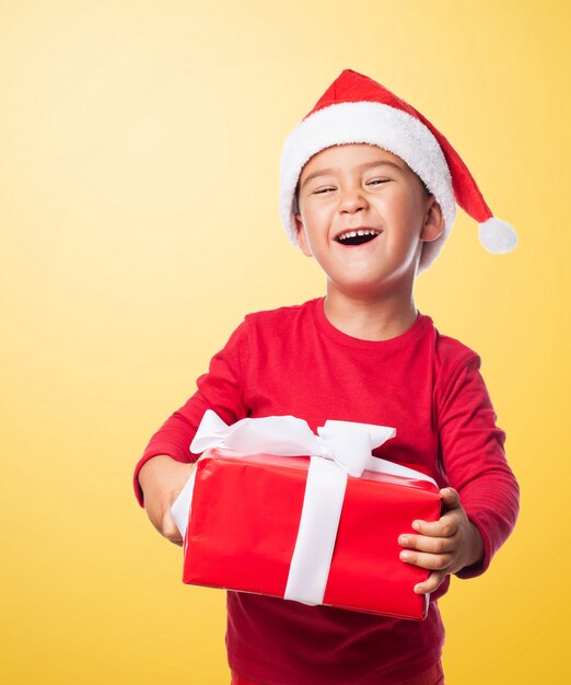 Kid laughing while holding a gift box