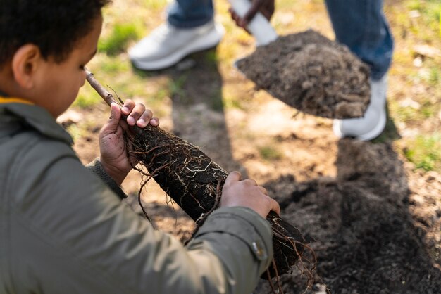 Kid learning how to plant a tree