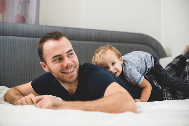 Kid lying on his father's back