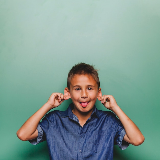 Kid making faces in classroom