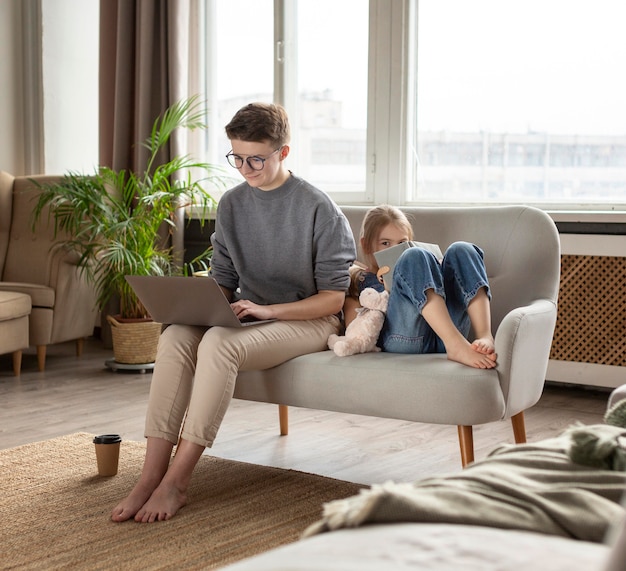 Kid and parent on couch full shot