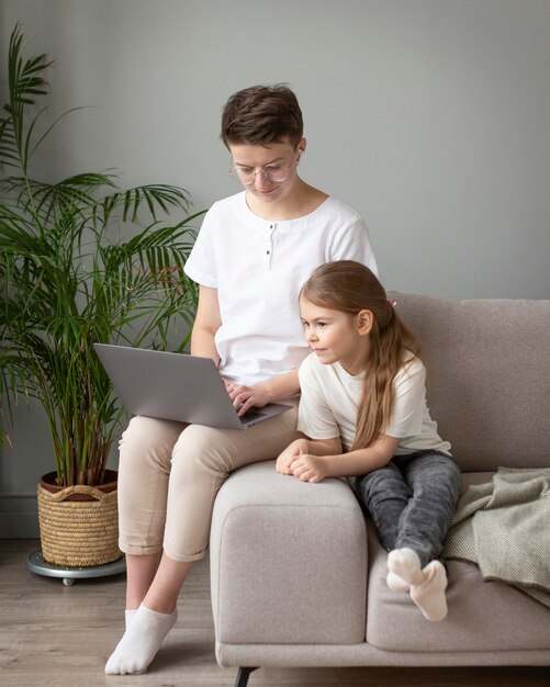 Kid and parent looking at laptop