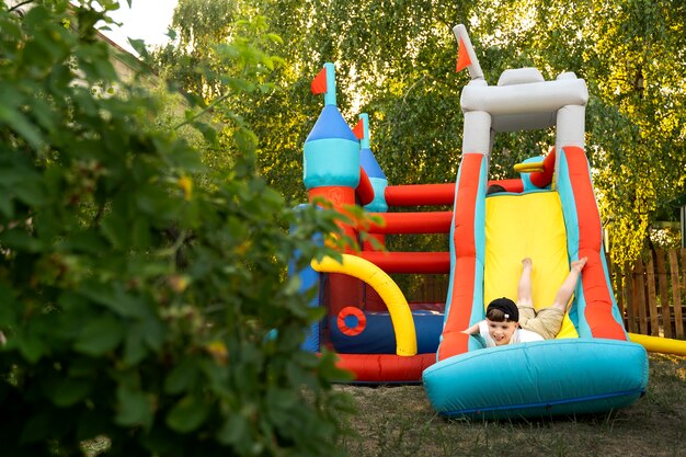 Kid playing in bounce house front view